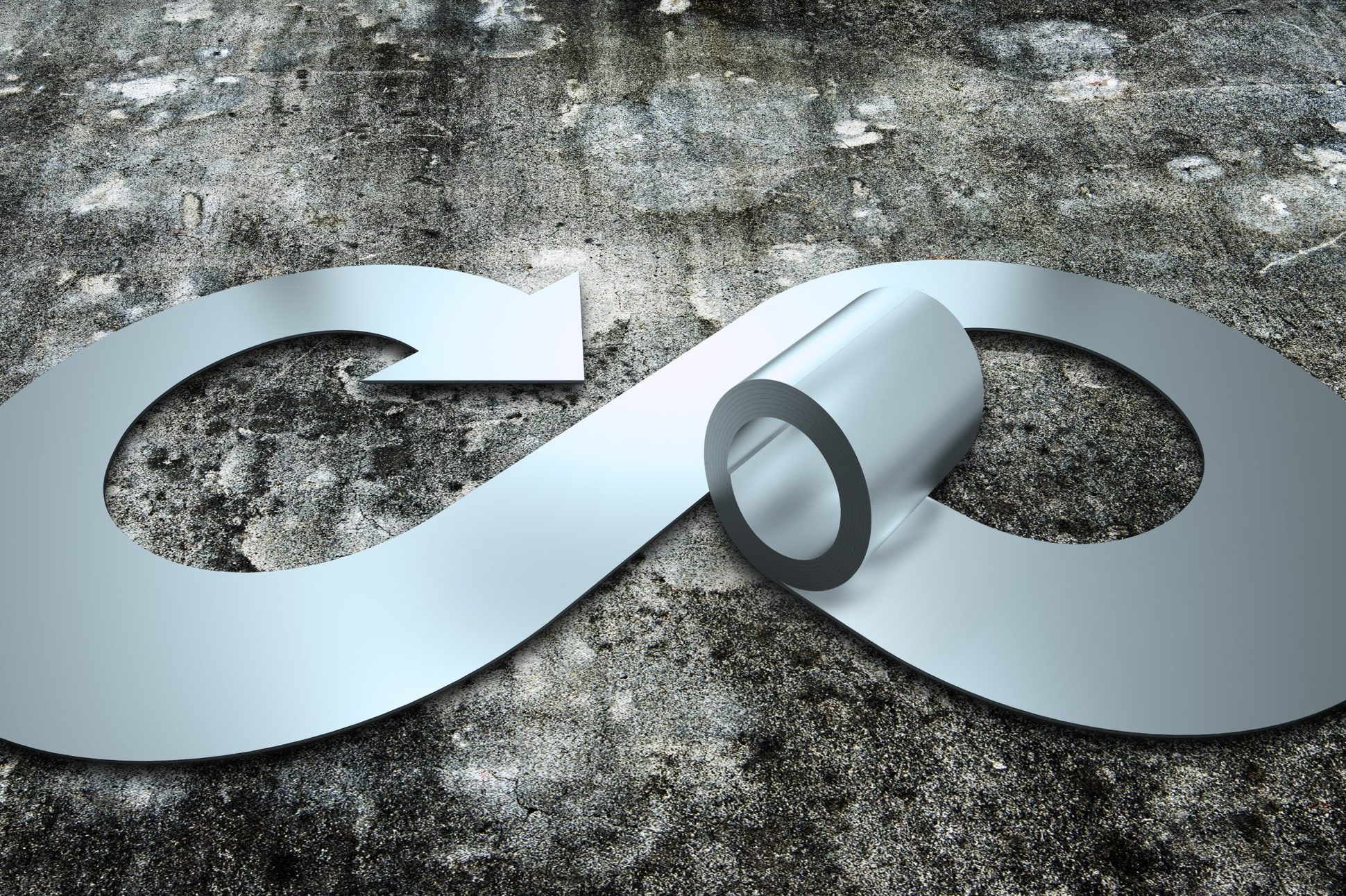 A sleek, metallic infinity symbol on a textured gray background, depicting continuity and endlessness with a circular cutout.