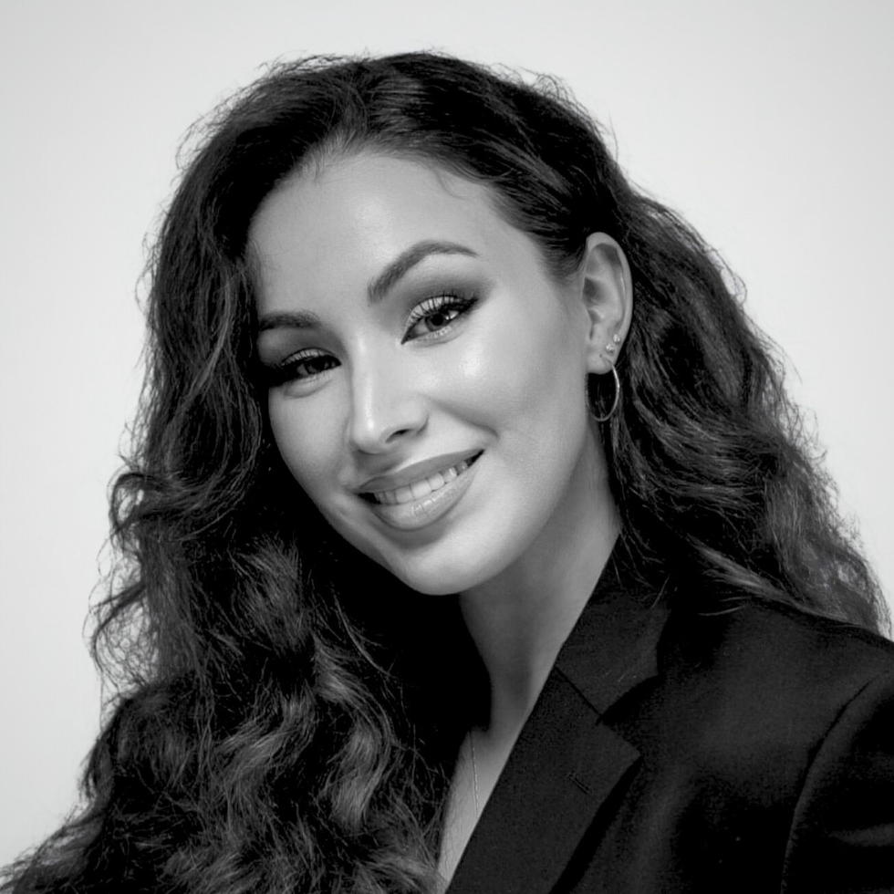 A woman with long, straight hair wearing a black blazer