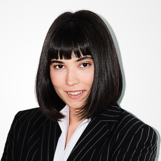 A woman with long, straight hair wearing a black blazer
