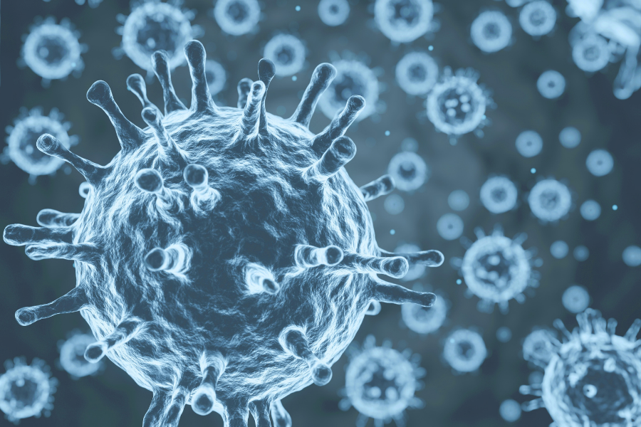 3D-rendered blue-gray virus particles surrounded by many smaller circular microbes on a dark background, with one large central sphere and spiky surface spikes.